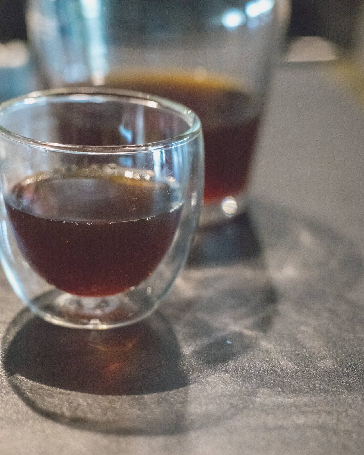 A glass of filter coffee in hard side light